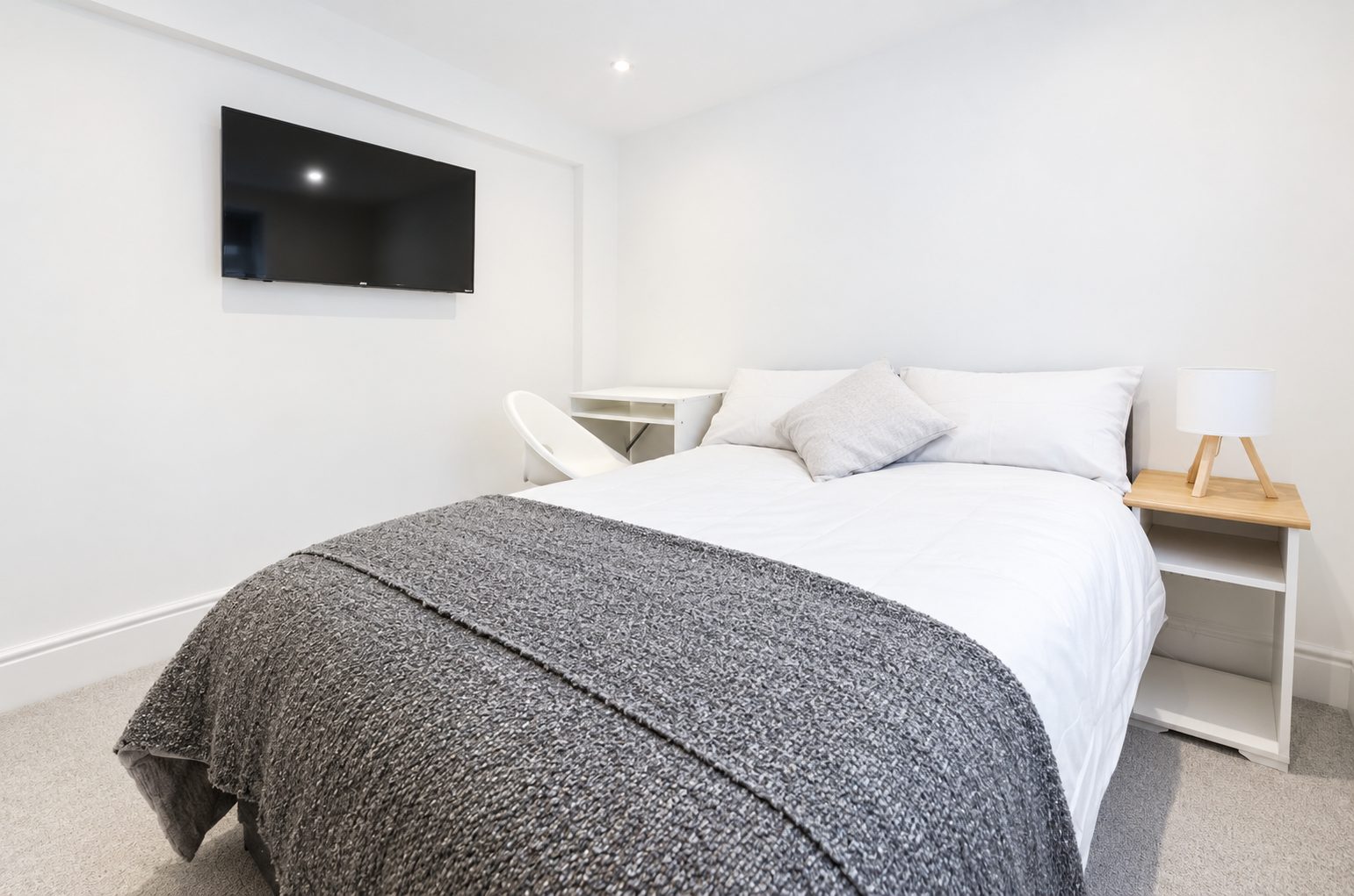 Double bed with wall-mounted TV